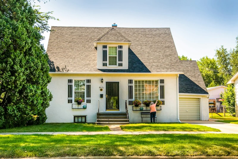 White cottage home supported through clearer property work