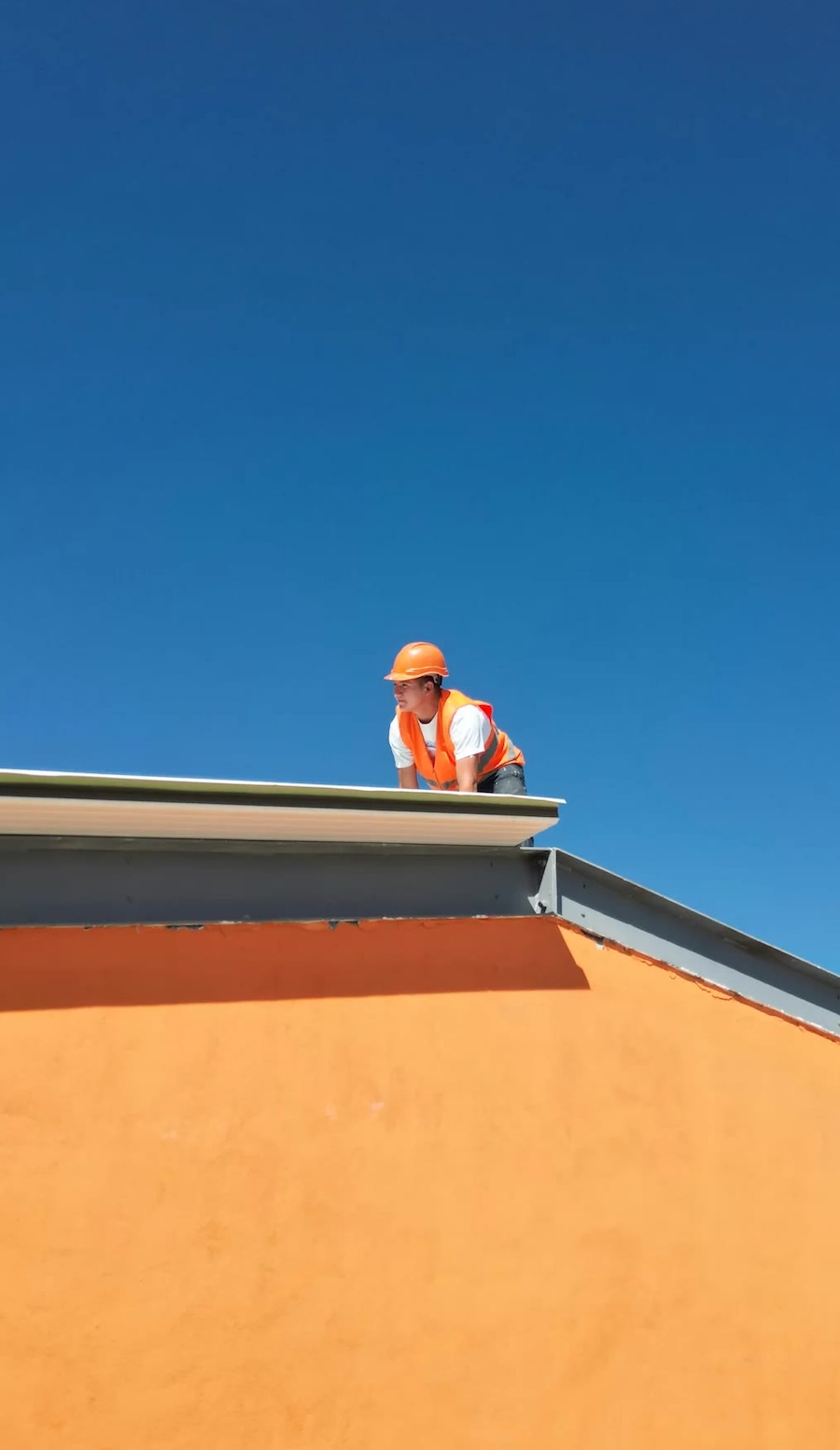 Rooftop worker supporting property maintenance