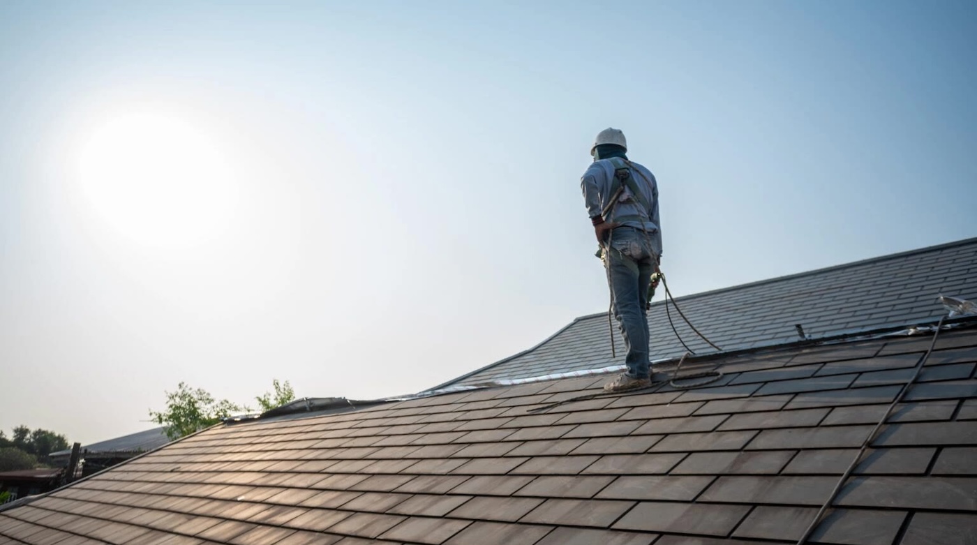 Roofer working under a clear sky